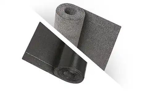 Two rolled roofing materials: the top roll has a rough, gray, sandpaper-like texture, while the bottom roll is smooth and black, both partially unrolled to show their surfaces. | GenFlex